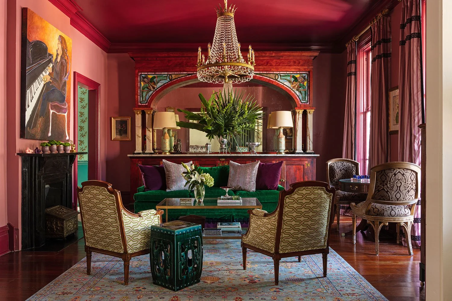 The Big Muddy Inn crimson parlor with emerald velvet sofa and crystal chandelier