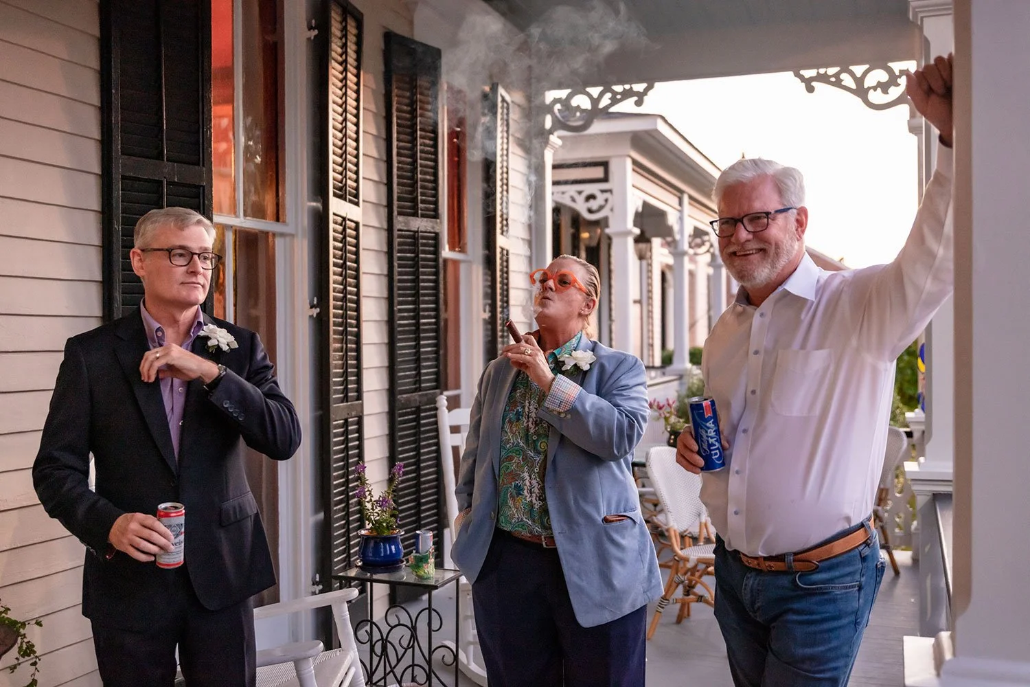 Guests enjoying cigars on the Big Muddy Inn porch at sunset